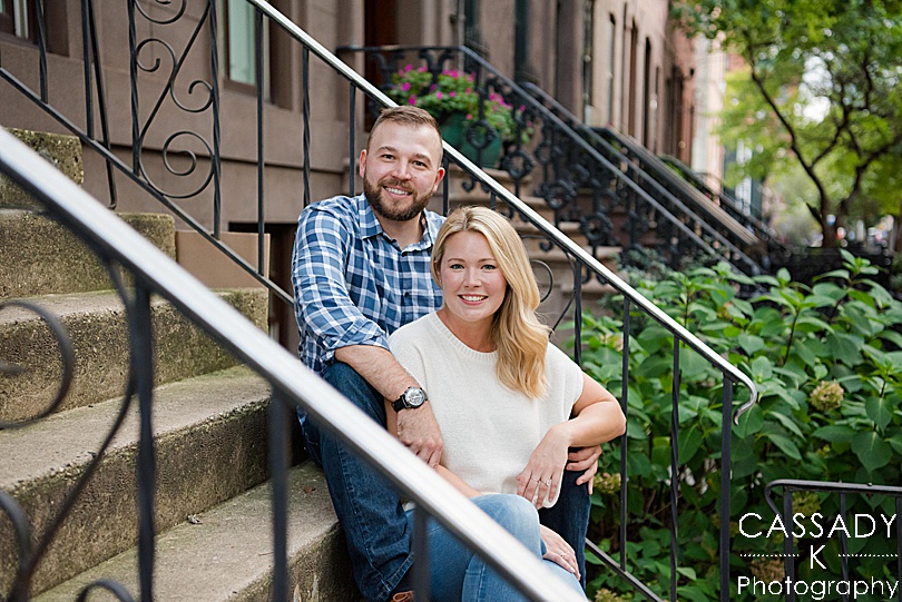 Bride and Groom hang on the front steps of their apartment in their neighborhood during a Jersey City Engagement Session