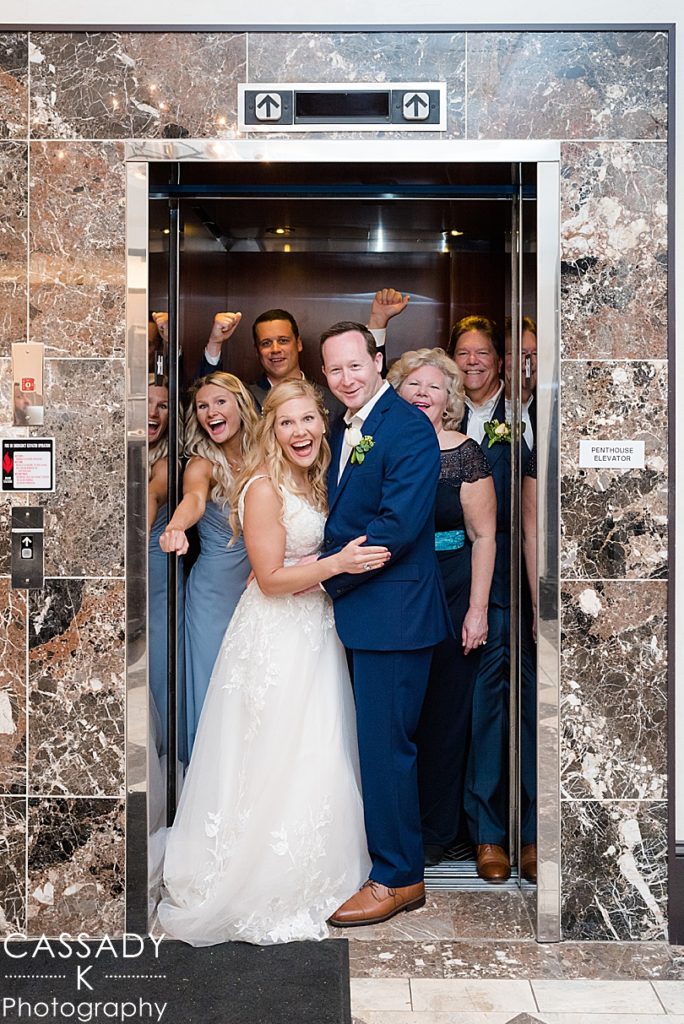 Bride and Groom's family celebrate in elevator before their Antique Loft Hoboken Wedding