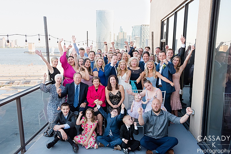Wedding guest group picture outside on balcony at Antique Loft Hoboken Wedding, NJ
