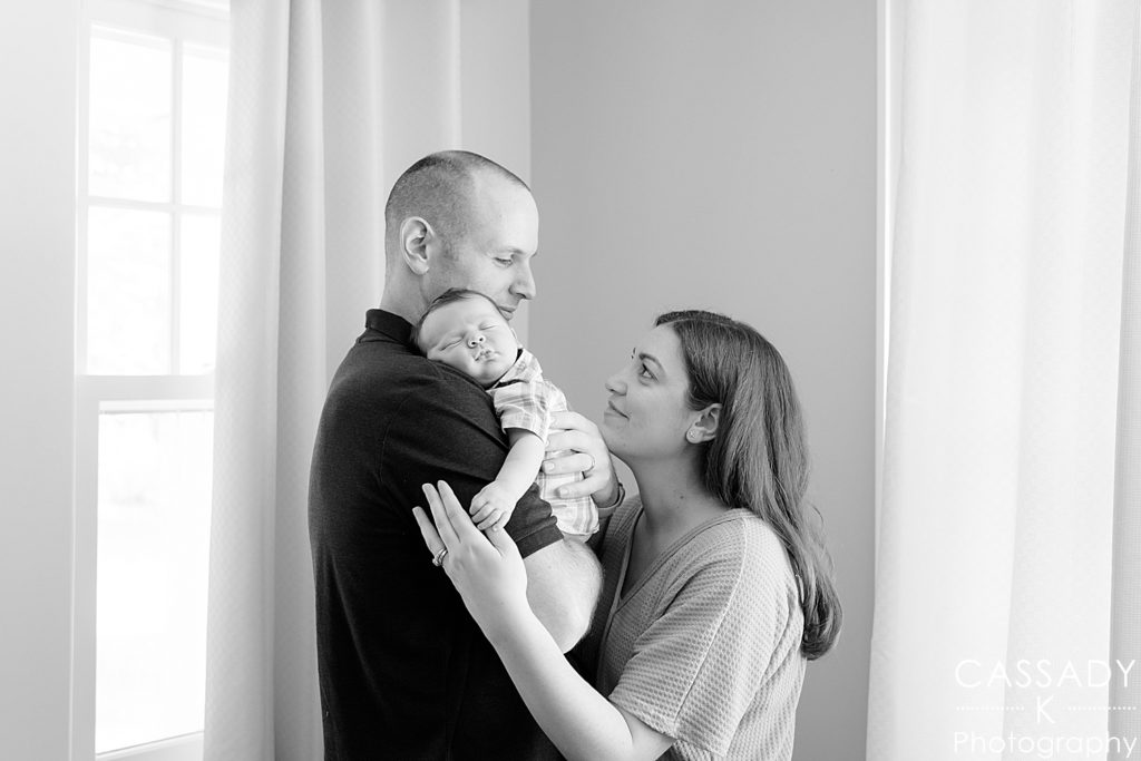 Black and white image of mother and father with newborn baby boy during pictures in Westchester, NY