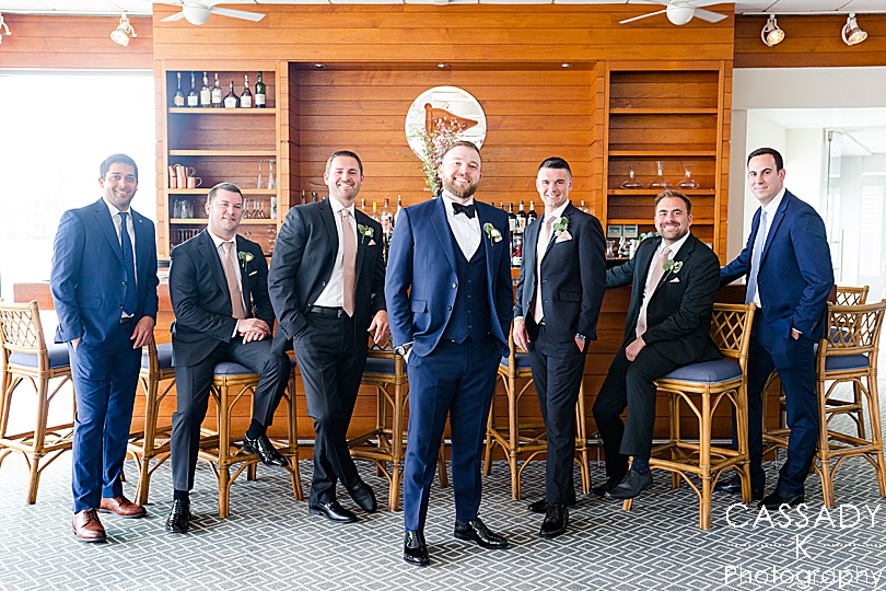 Picture of groomsmen posing by bar at Spring Tokeneke Club Wedding
