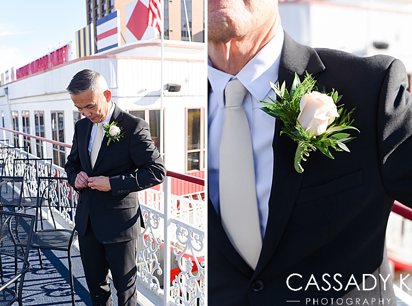 Groom fixing suit at fall Gateway Clipper wedding