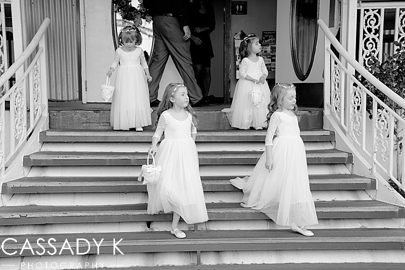 Flower girls coming down stairs before fall Gateway Clipper wedding