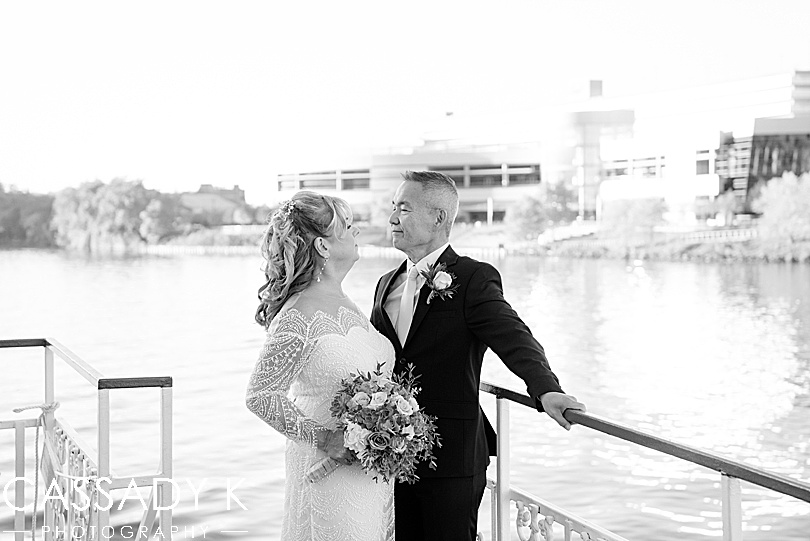Bride and groom looking at each other on the water in fall Gateway Clipper wedding