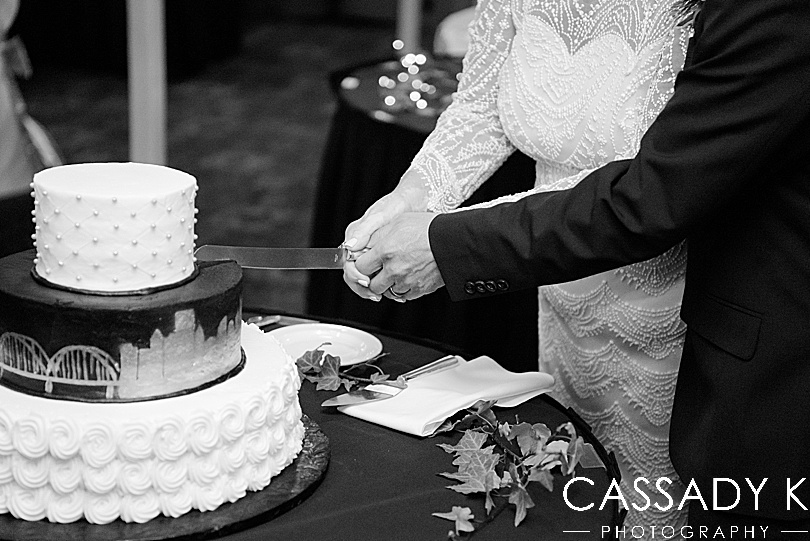 Close up of bride and groom cutting cake at fall Gateway Clipper wedding