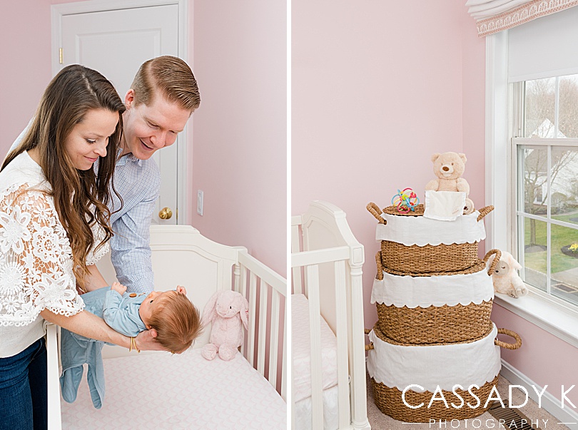 Mom and Dad putting baby girl into her white crib during Doylestown PA newborn pictures. 