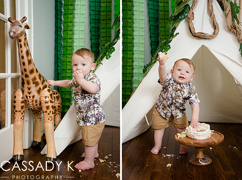 Baby boy with blow up giraffe for wild one year old birthday