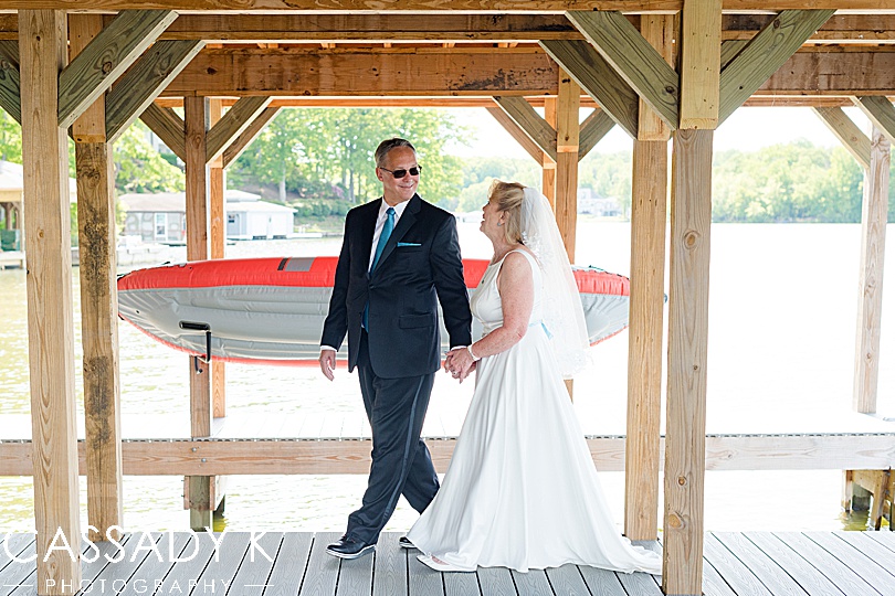 Bride and groom walking on dock after their small wedding on Lake Anna, VA