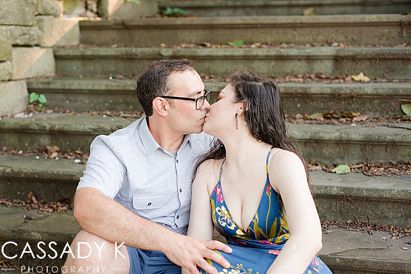 Man and woman kissing on stone steps during Rockwood Hall engagement photos