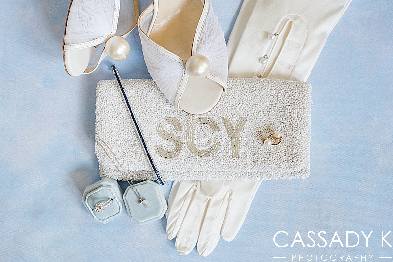 Custom beaded clutch and long bridal gloves on periwinkle backdrop