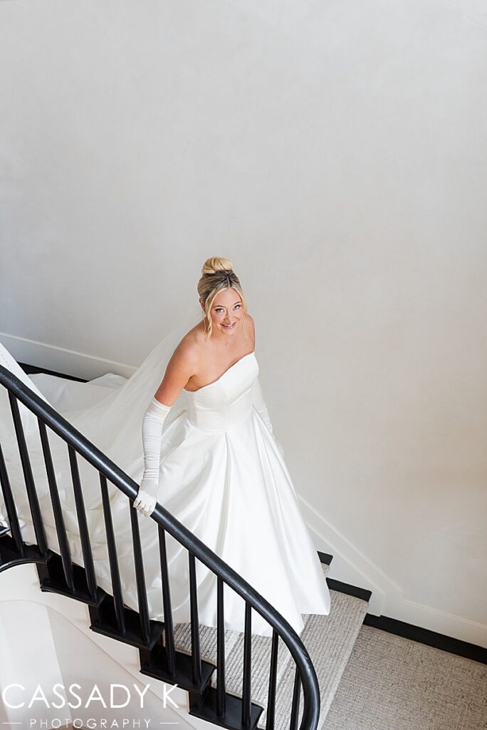 Bride walking down stairs in wedding gown