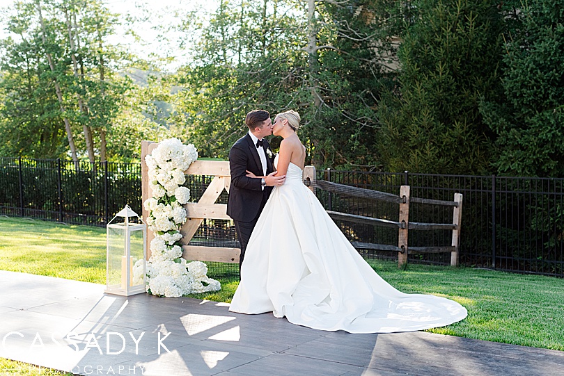 Bride and groom kissing in backyard of Private Estate Tented Wedding