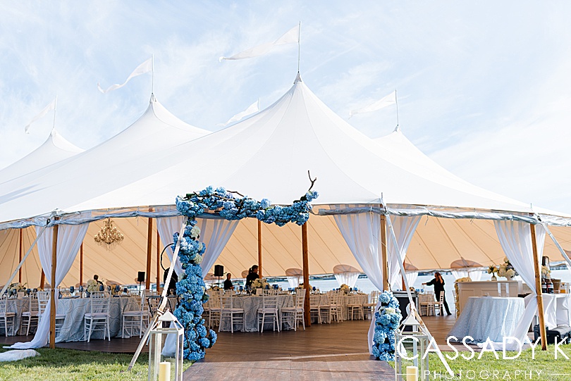 Hydrangea flower arch in front of sailcoth tent by the water