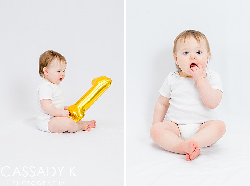 Baby girl celebrating one year old birthday with travel portrait studio session