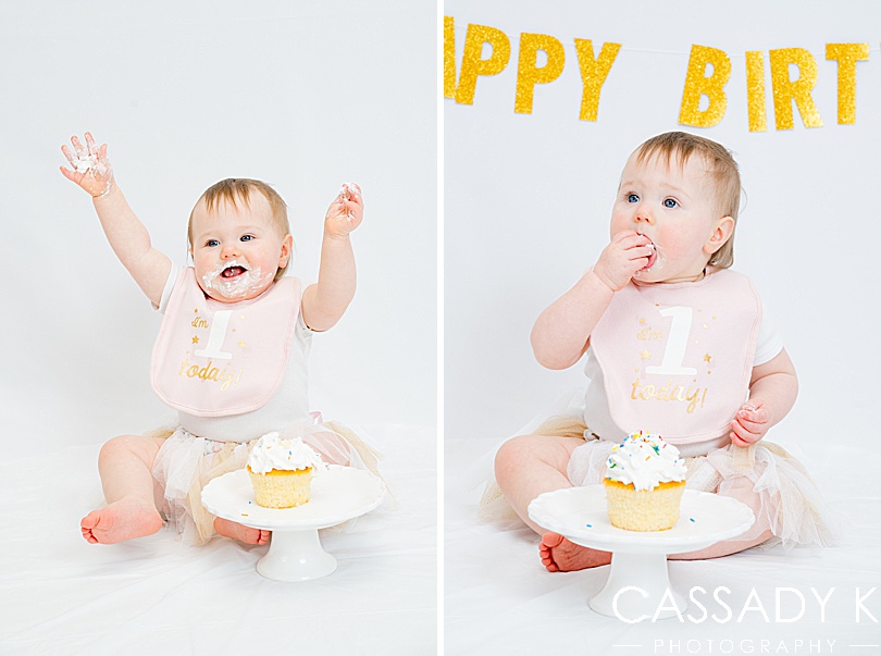 Baby girl with frosting on her face during travel portrait studio session