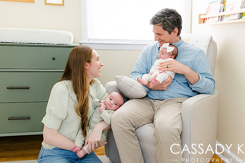 Mom and dad in nursery holding twin babies in Philadelphia Lifestyle Newborn Session