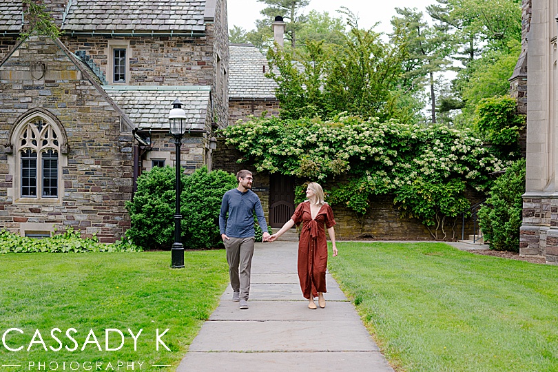 Couple walking on path in Princeton, NJ during engagement session