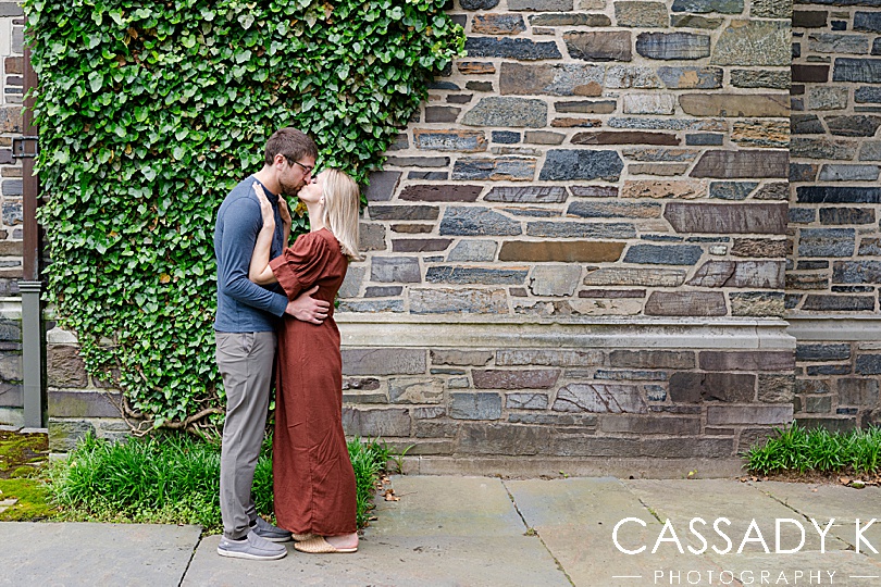Couple kissing in front of ivy wall during Princeton Engagement Pictures