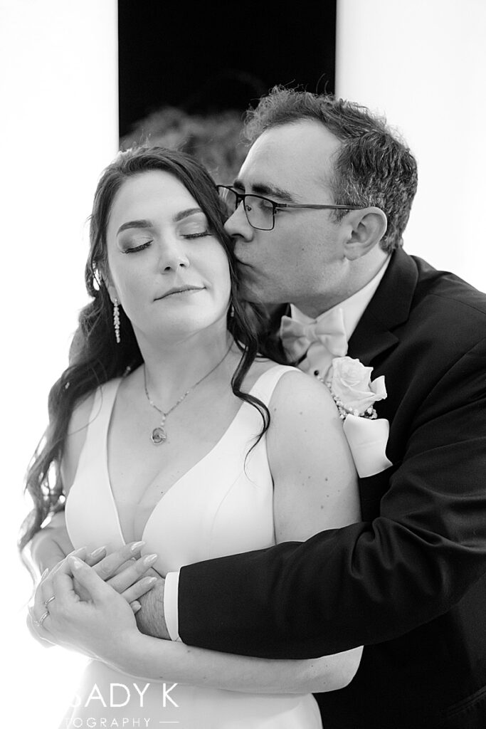 Bride and groom hugging in black and white