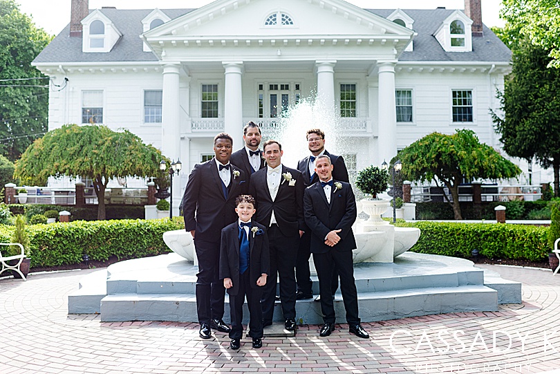 Groom and groomsmen in front of Briarcliff Manor