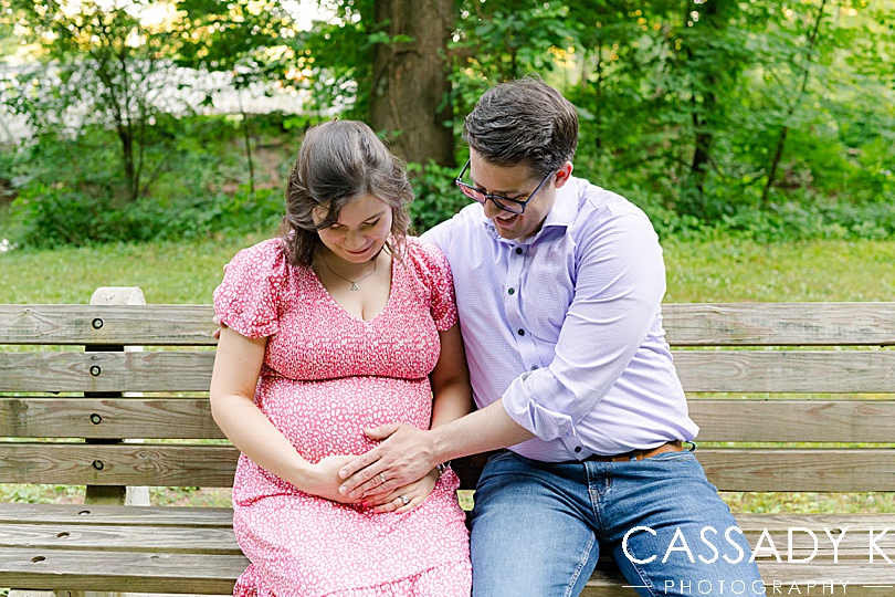 man and woman looking at pregnant belly