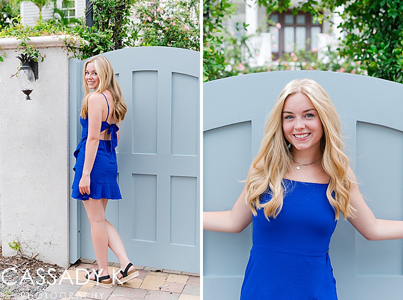 Girl in blue dress standing in front of blue door during Longboat Key Senior Portrait Session