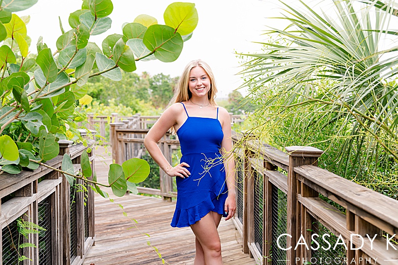 Girl in blue dress standing on pier