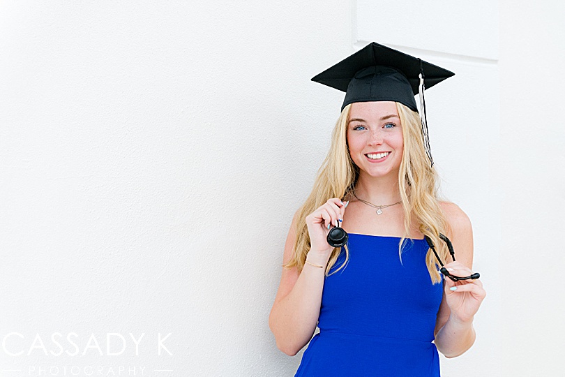 Girl in blue dress with graduation hat during Longboat Key Senior Portrait Session