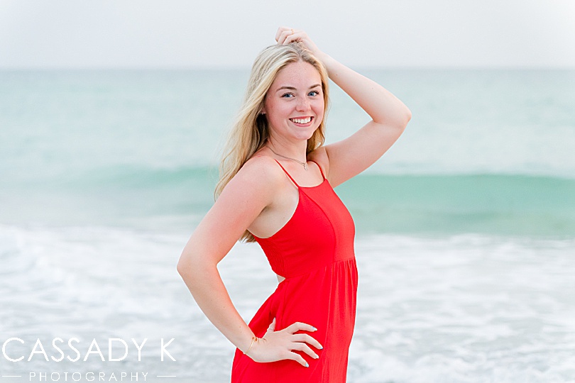 Girl posing on beach in red dress during Longboat Key Senior Portrait Session