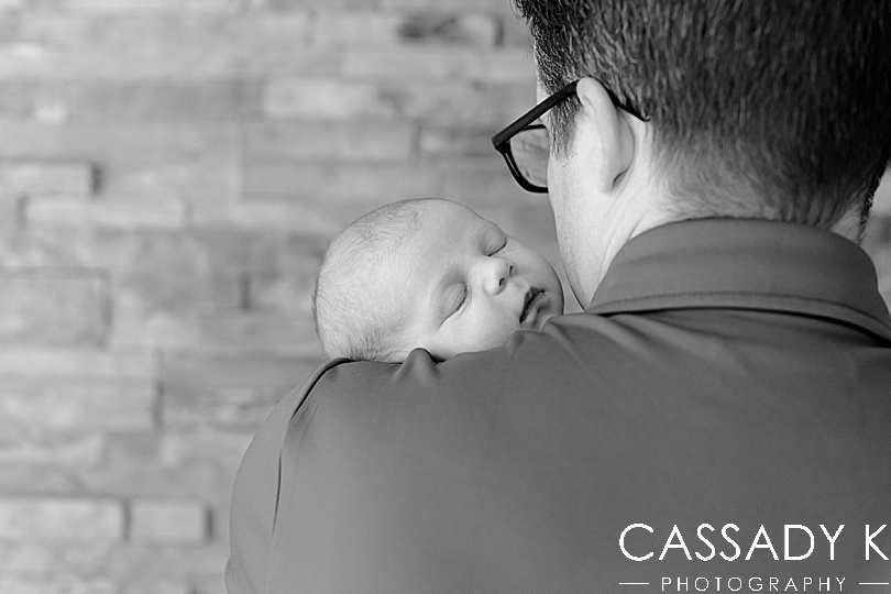 Dad holding baby girl on shoulder during Lansdale Lifestyle Newborn Session