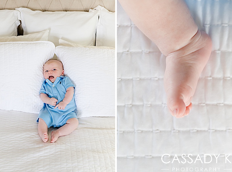 Baby boy in a blue Polo onesie propped up by pillows during a growing family lifestyle session in Pittsburgh