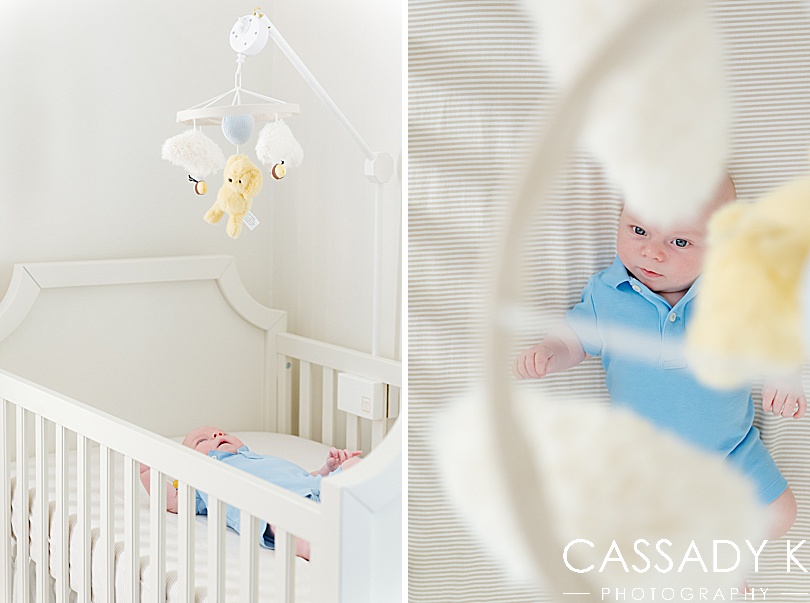 Baby boy staring up at a Classic Winnie the Pooh crib mobile during a growing family lifestyle session