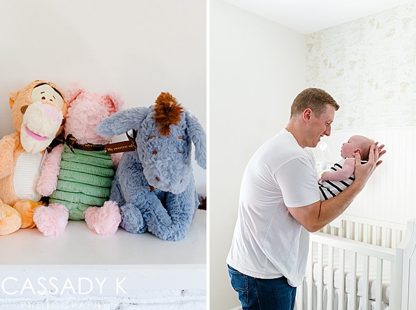 Winnie the Pooh stuffed animals and dad holding baby boy in nursery during Growing Family Lifestyle Session