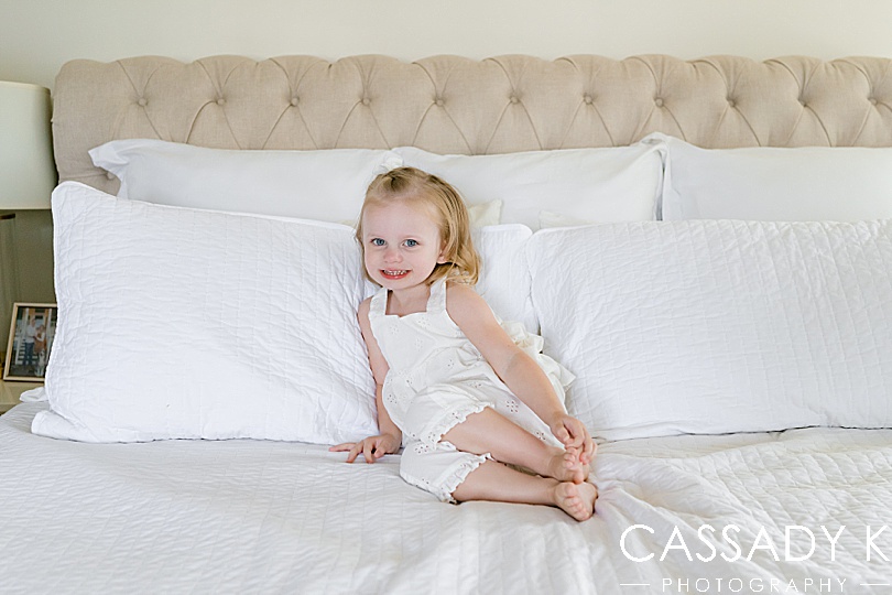 Young girl sitting in bed