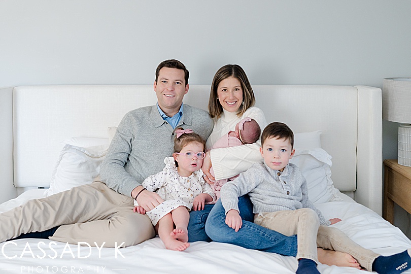 The whole family of five in parents' bed for a picture at a northern NJ newborn session