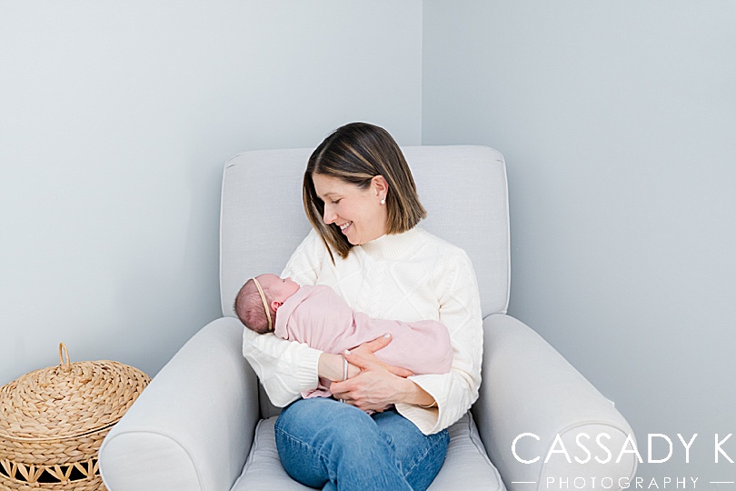 New mom holds newborn baby girl for pictures