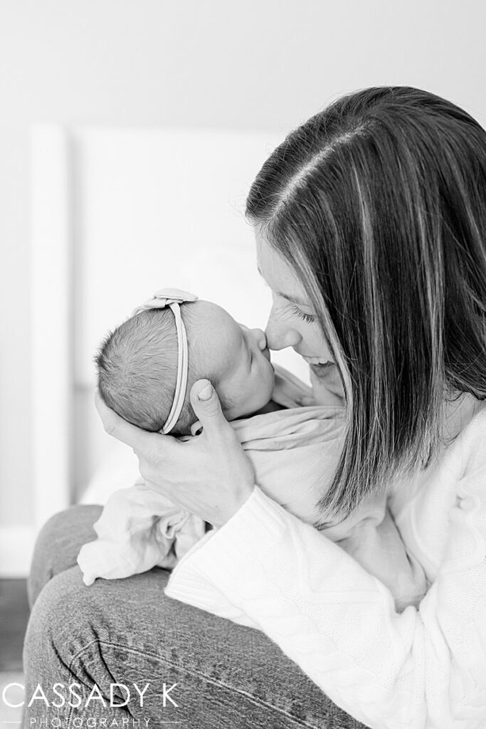 Black and white of mom touching noses with baby girl during a newborn session in Northern NJ