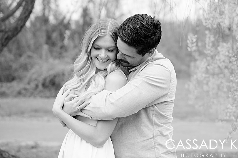 Black and white of a couple snuggling under the Cherry Blossoms in Fairmount Park, Philadelphia, PA