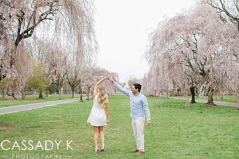 Man spins his wife in the middle of a row of Cherry Blossom trees in Fairmount Park, Philadelphia