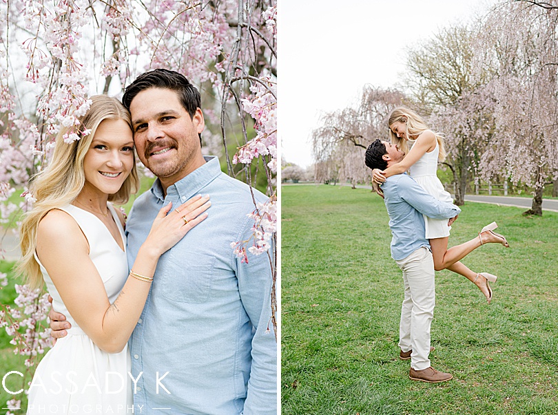 Husband picks up his wife in the middle of a row of Cherry Blossom trees in Fairmount Park, Philadelphia