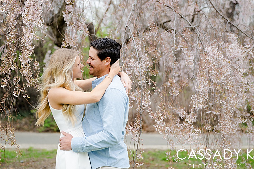 Couple laughing under the blooming Fairmount Park Cherry Blossoms 