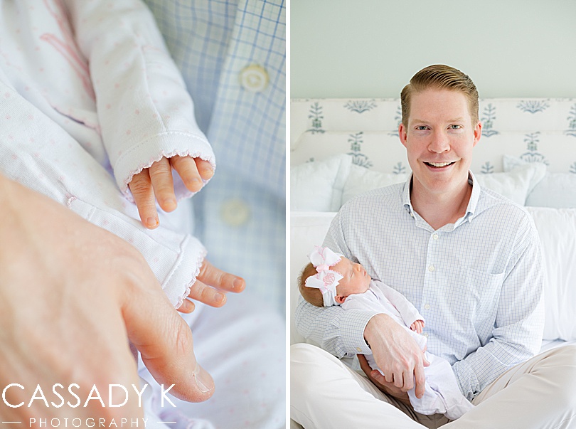 Father proudly holds his newborn daughter during an in-home family session.