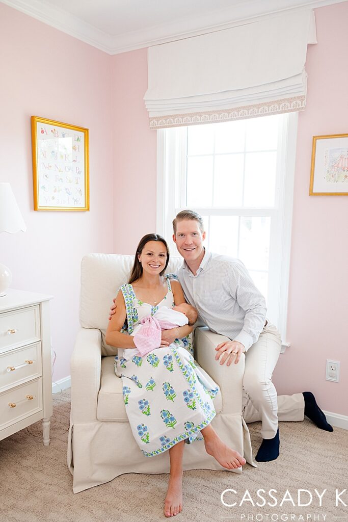 Mom and Dad hold their newborn baby girl in her nursery in their Doylestown, PA home.